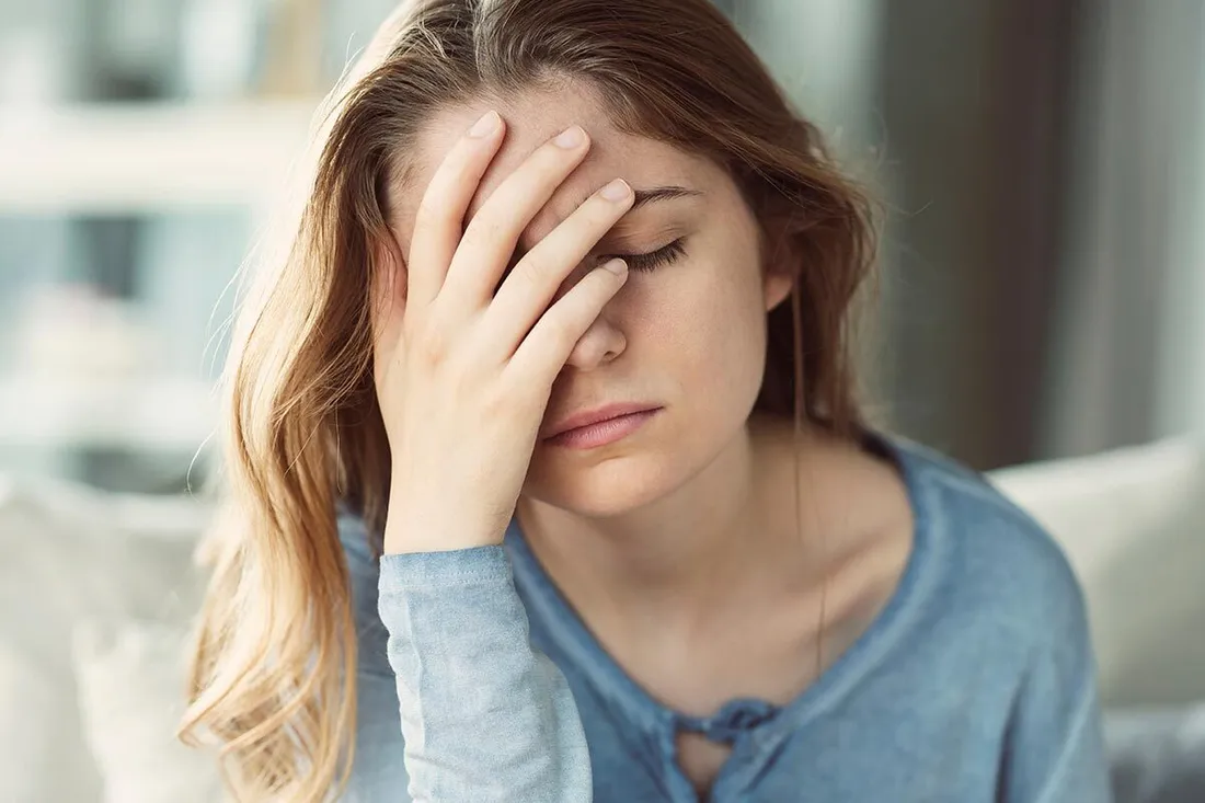 Frau hält sich gestresst die Hand vor den Kopf